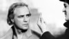 US actor Marlon Brando is directed 05 March 1972 in Paris during the filming of "Last tango in Paris" by Italian writer-director Bernardo Bertolucci (R)